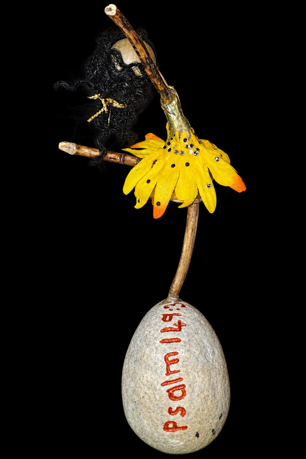 Handmade ballerina in a yellow petal skirt on a stone inscribed Psalm 149:3